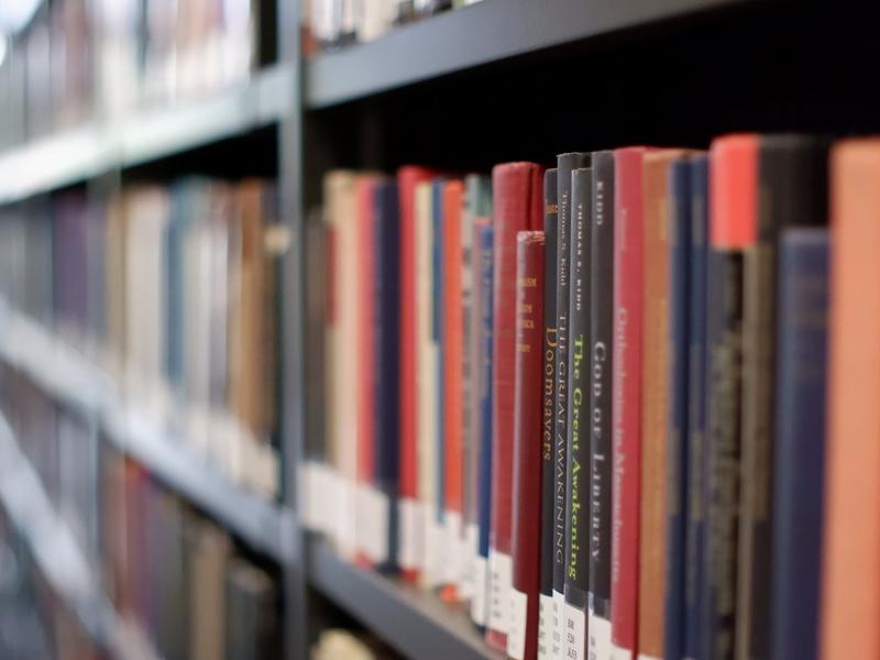 a row of books on a shelf in the library 