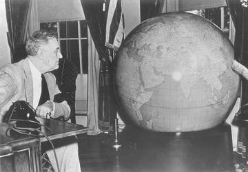 Franklin Delano Roosevelt looking at a globe