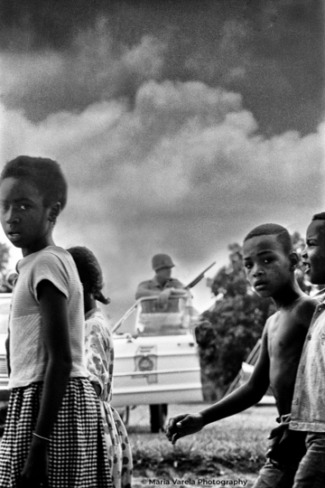 Children framed by sharp-shooter, by Maria Varela